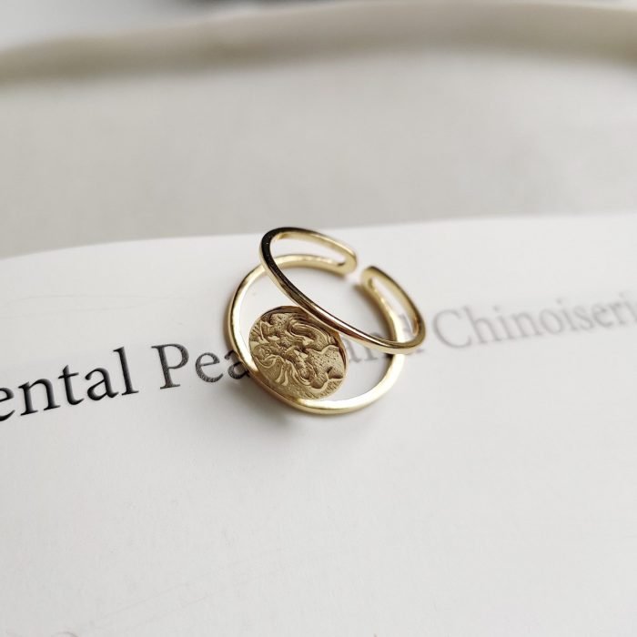 woman's gold silver ring with mermaid