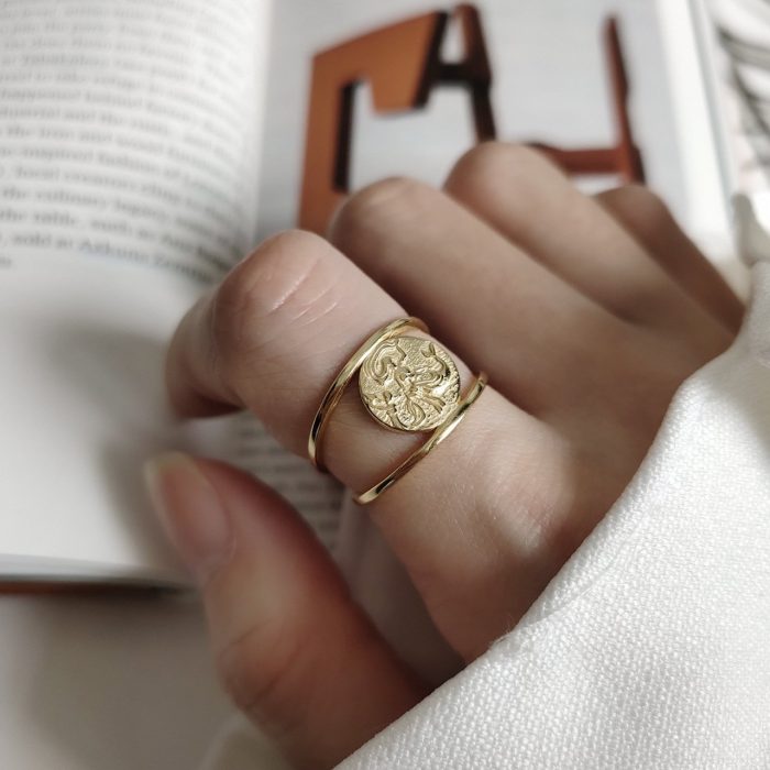 woman's gold silver ring with mermaid