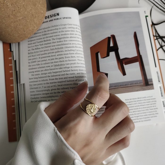 woman's gold silver ring with mermaid